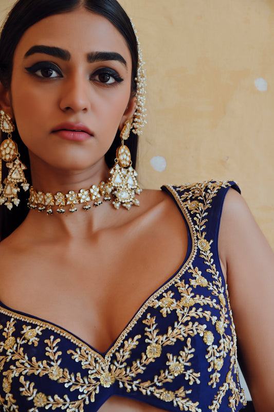 ROYAL BLUE DEEP NECKLINE EMBROIDERED SLEEVELESS BLOUSE WITH FLORAL BUTTI EMBROIDERED LEHENGA AND DUPATTA