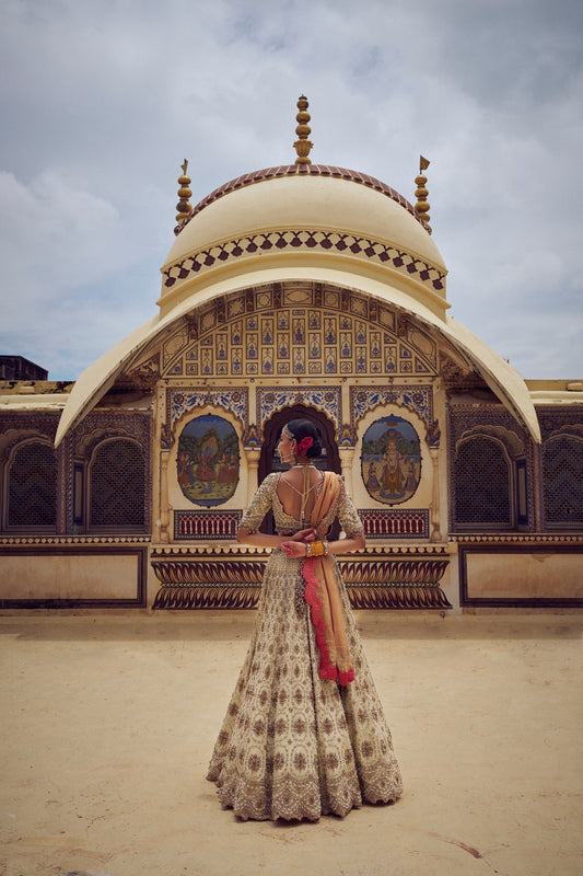 GOLD TISSUE LEHENGA CHOLI WITH A PEACH TISSUE DUPATTA