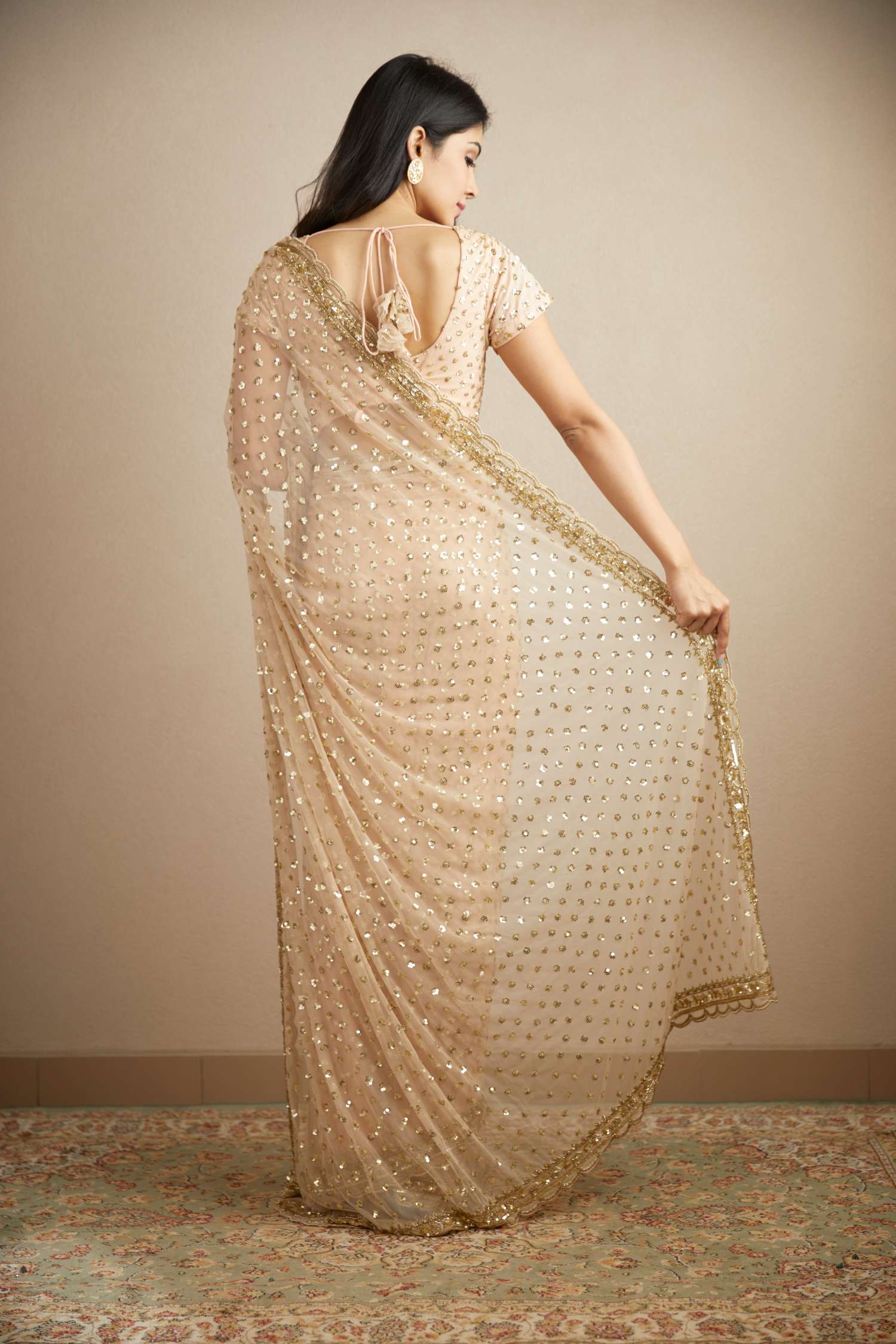 Back Angle view of Peach Pink Heavy Shimmer Work Saree Set