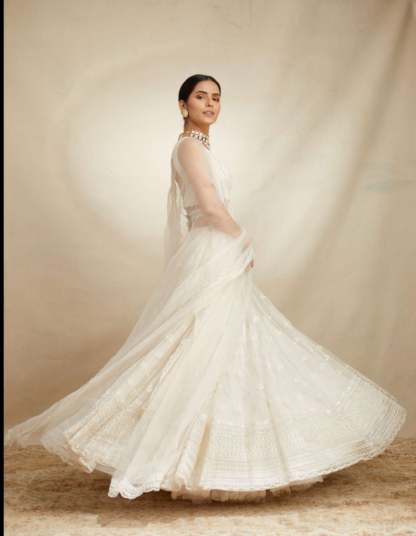 Side Front view of White Thread Work Lehenga Set