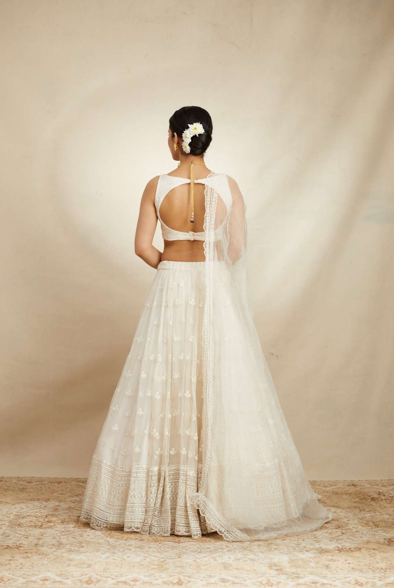 Back angle view of White Thread Work Lehenga Set