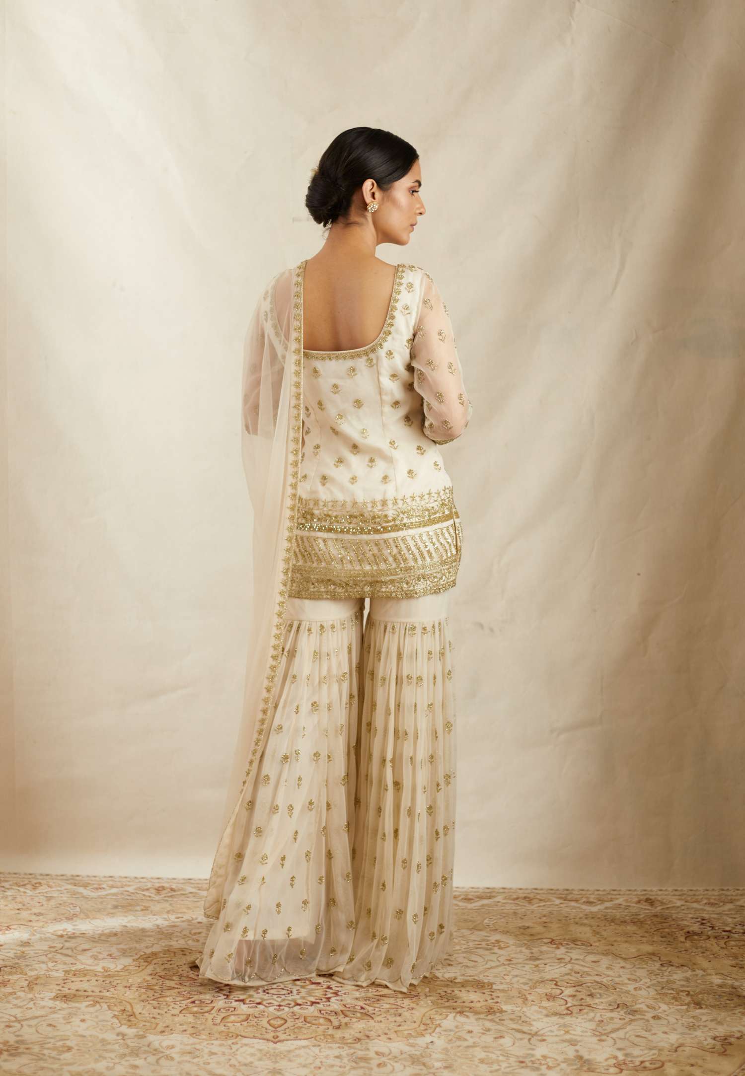 Back Angle view of Off White Bootie Kurti Organza Sharara Set