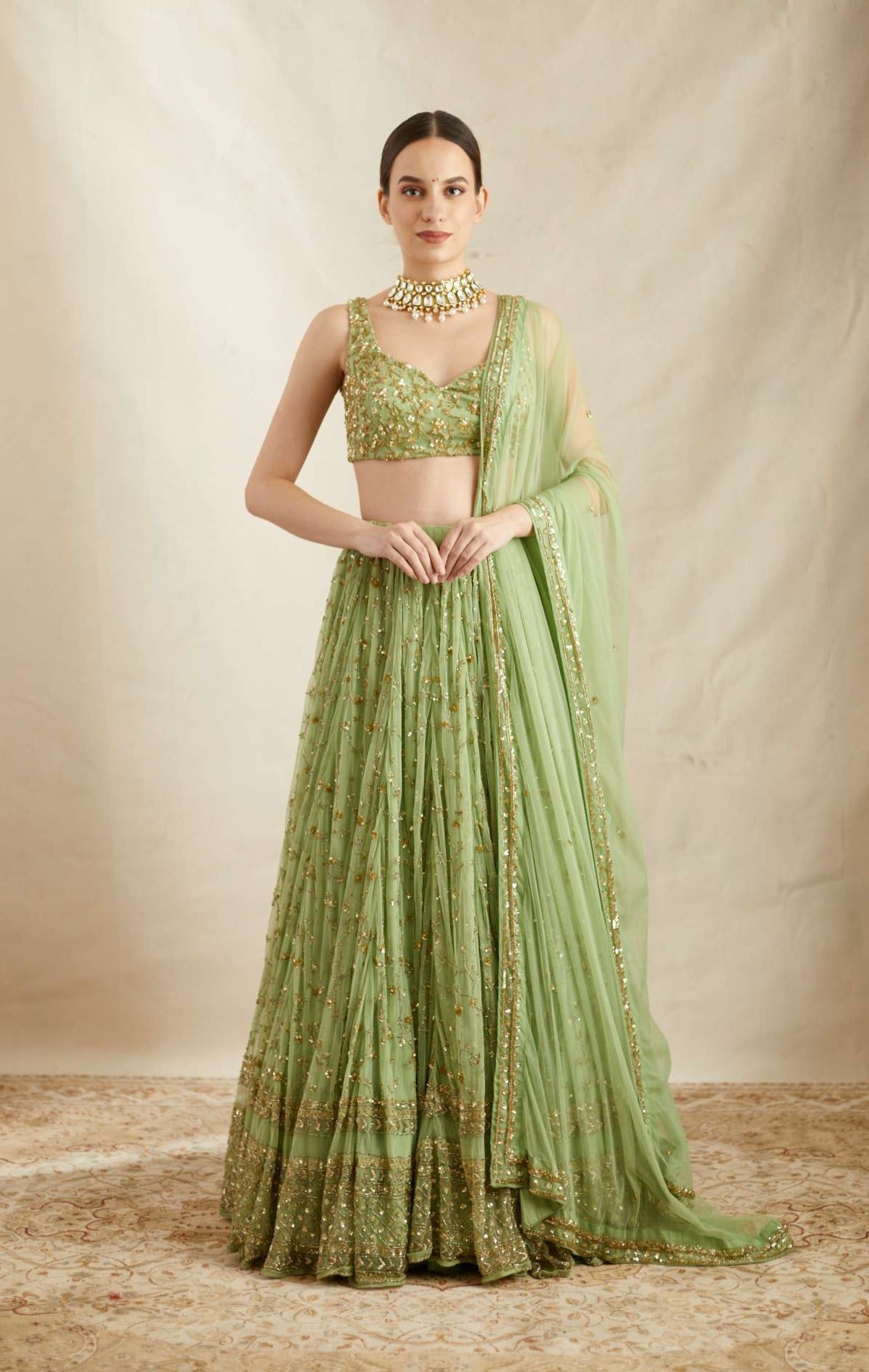 Front view of Mint Green Net Heavy Jaal Work Lehenga Set