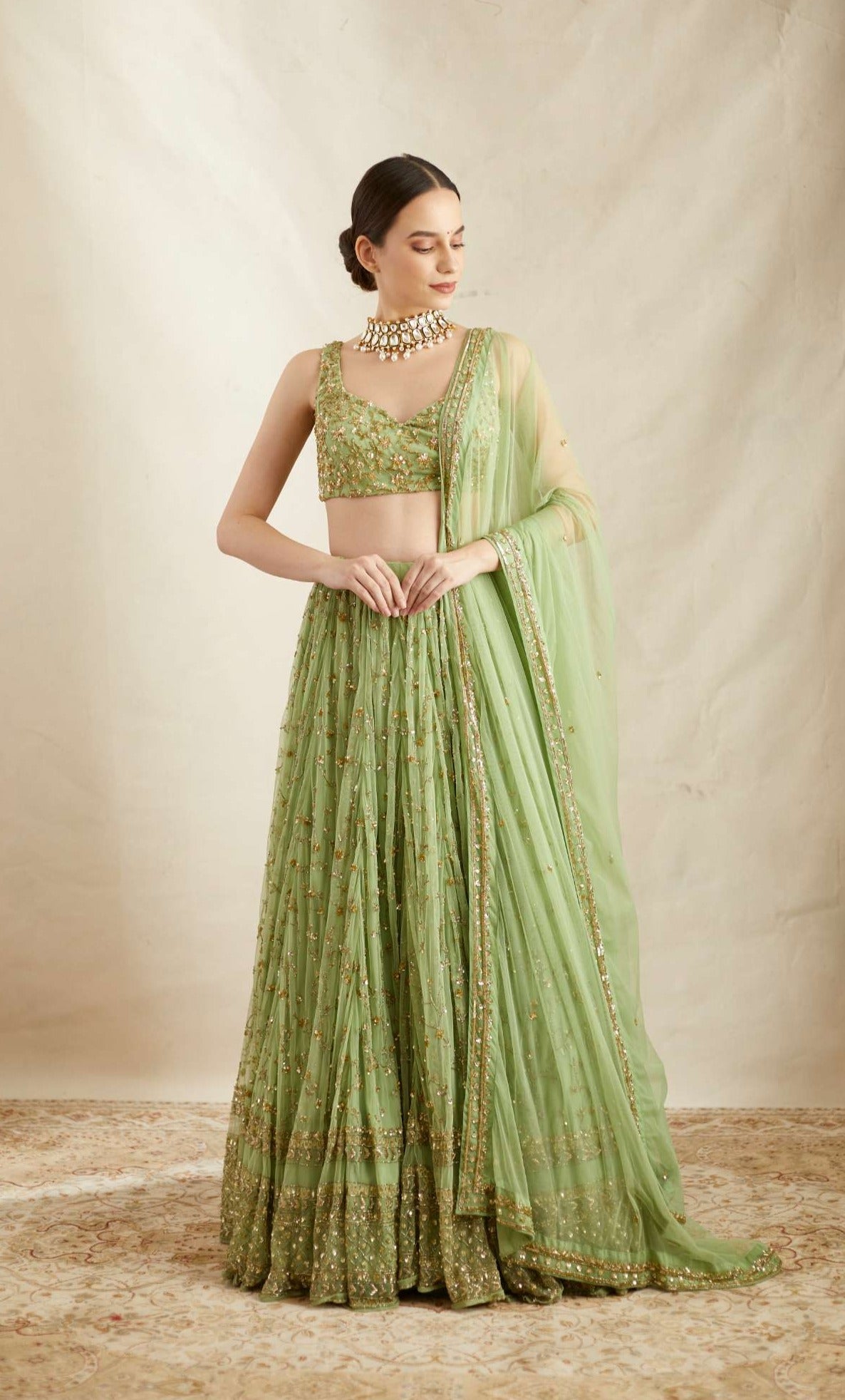 Front view of Mint Green Net Heavy Jaal Work Lehenga Set