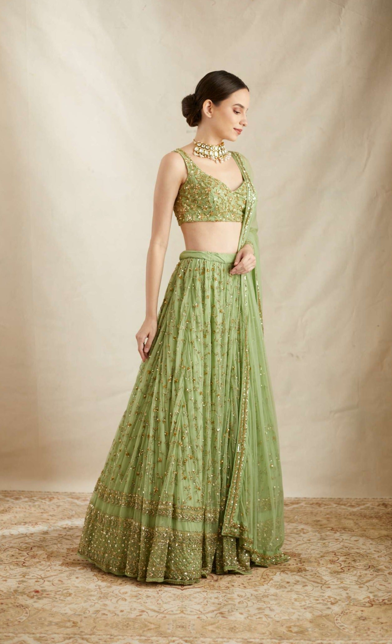 Side view of Mint Green Net Heavy Jaal Work Lehenga Set