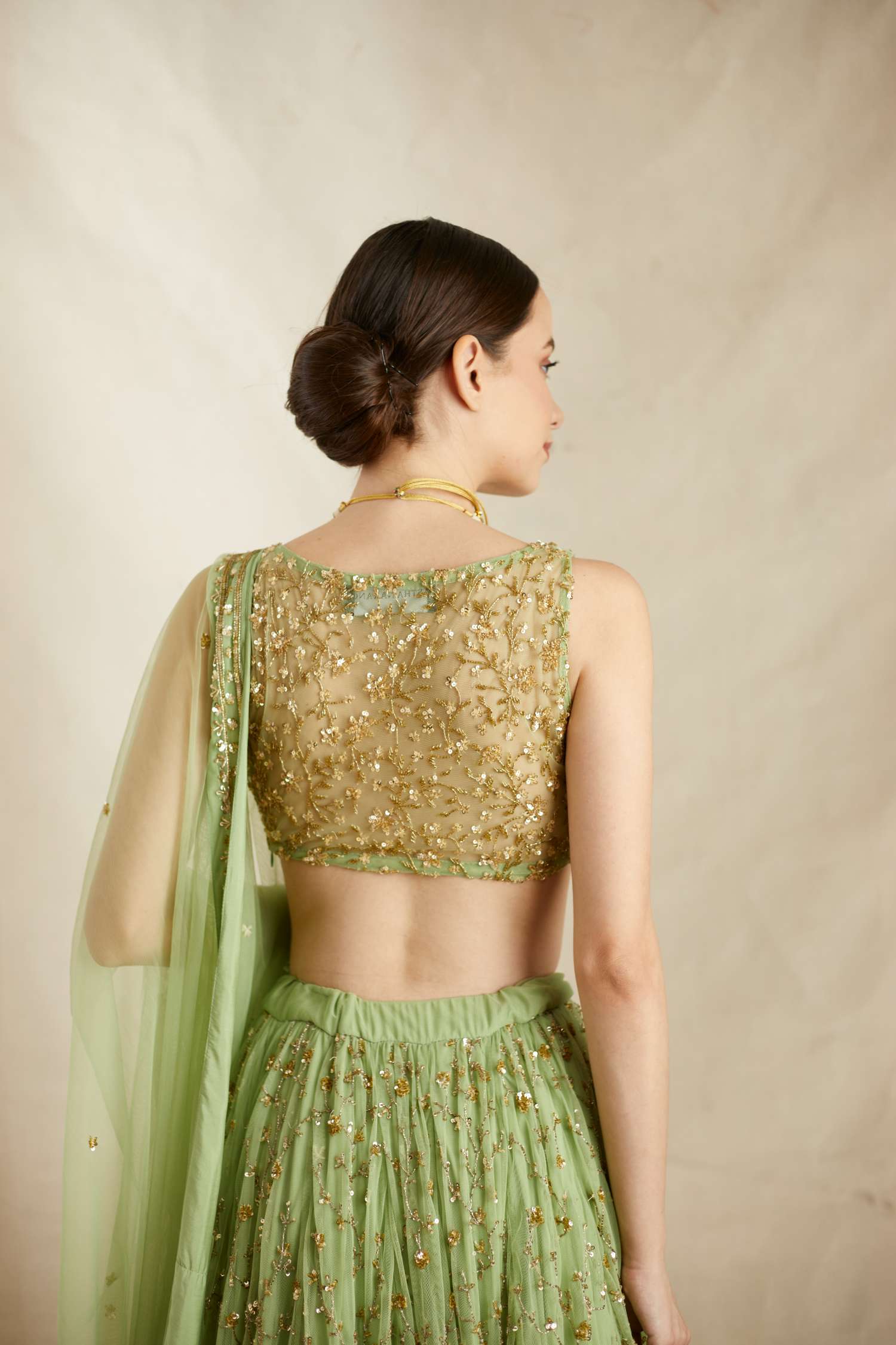 Side view of Mint Green Net Heavy Jaal Work Lehenga Set
