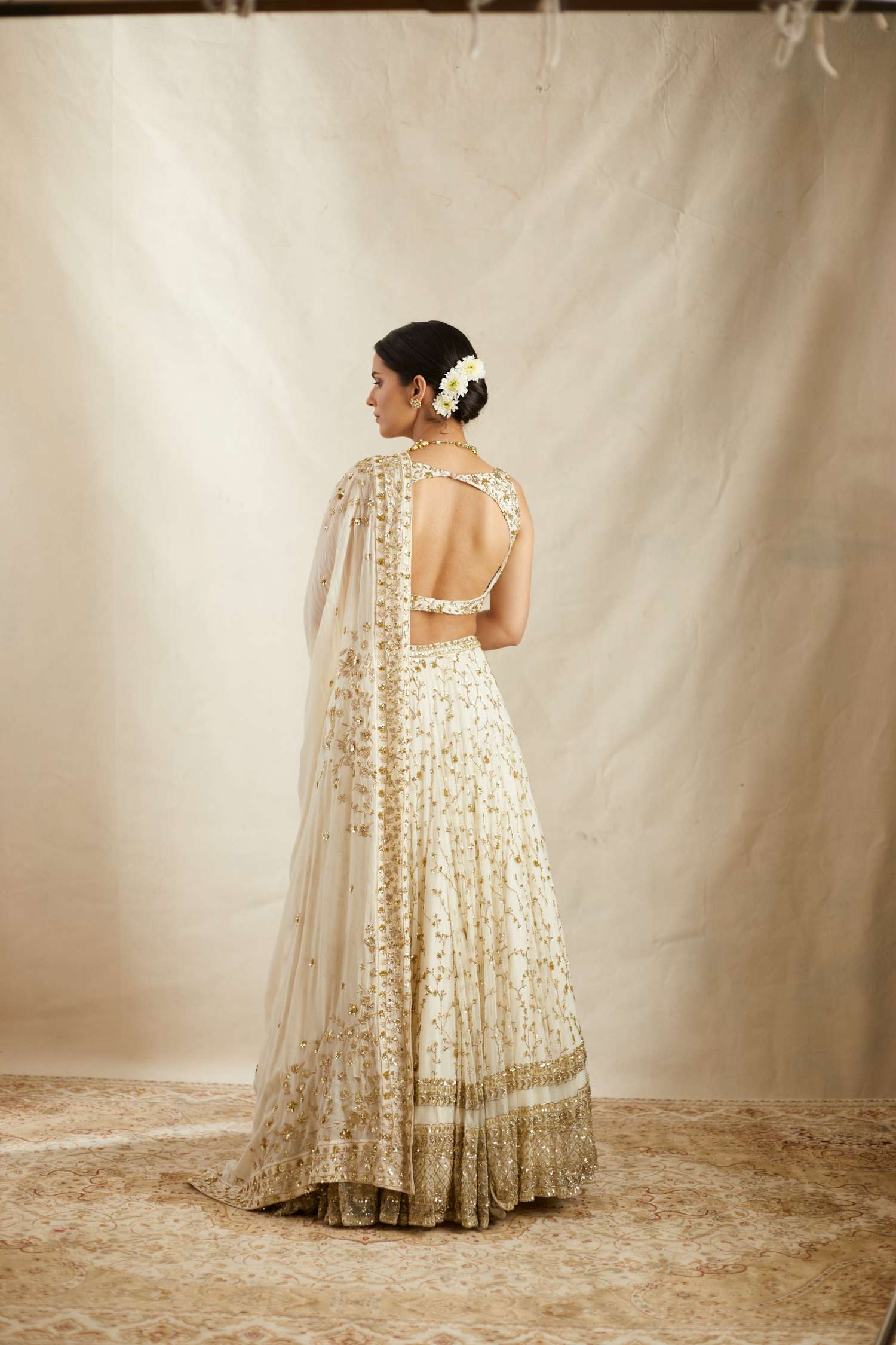 Back angle view of Off White Heavy Jaal Work Lehenga Set