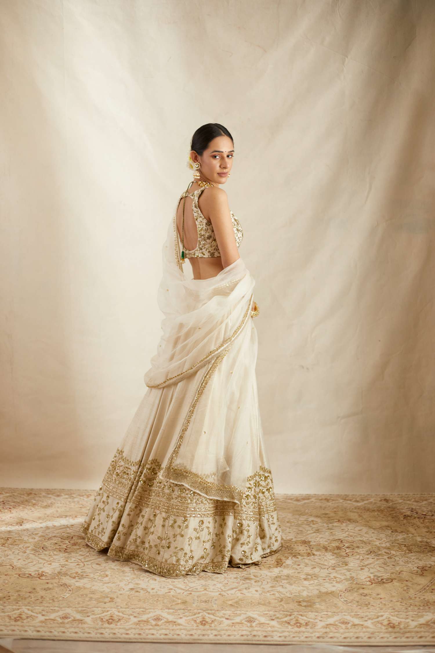Side view of Off White Gold Work Raw Silk Lehenga Set for Women