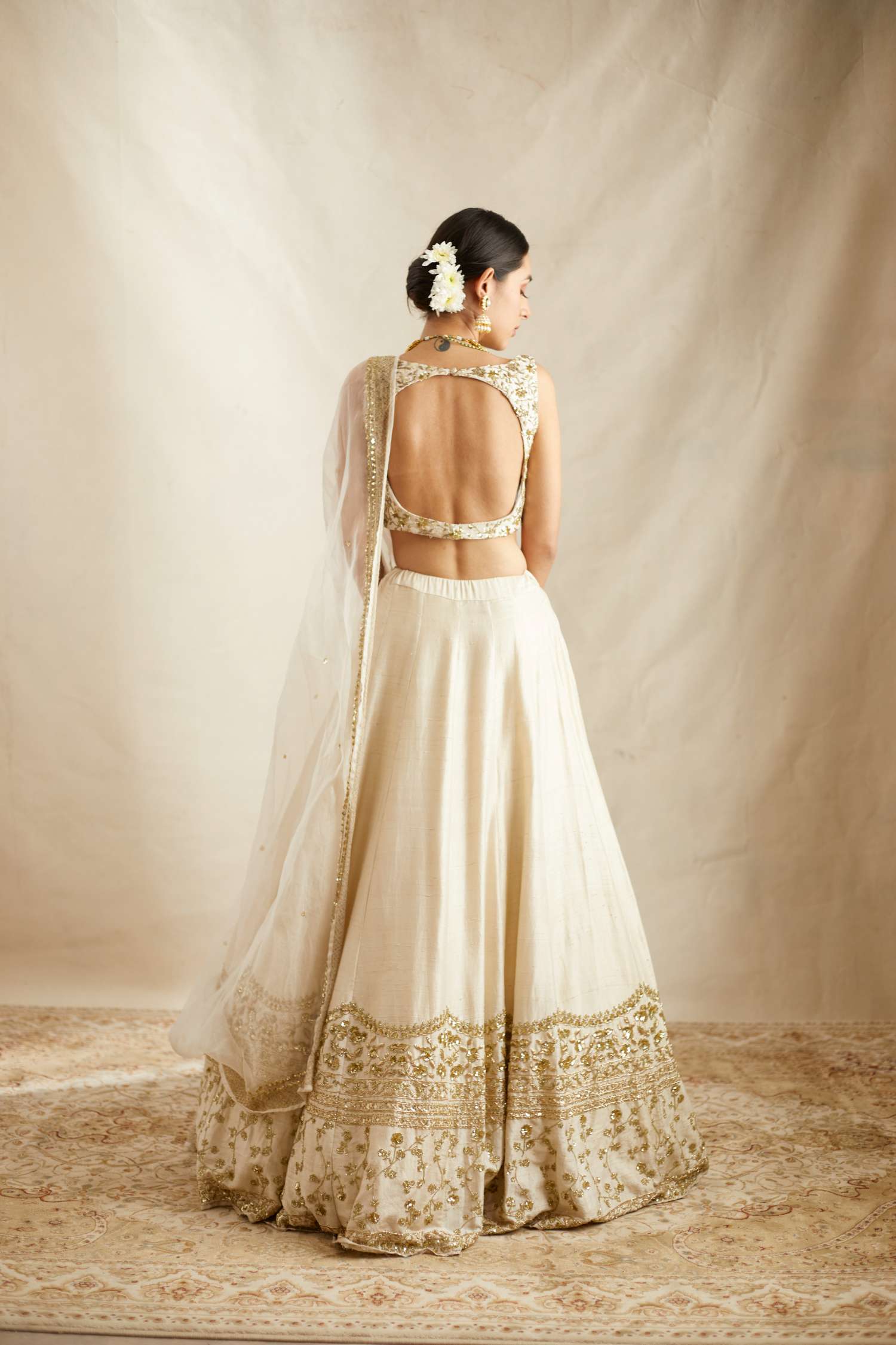 Back Angle view of Off White Gold Work Raw Silk Lehenga Set