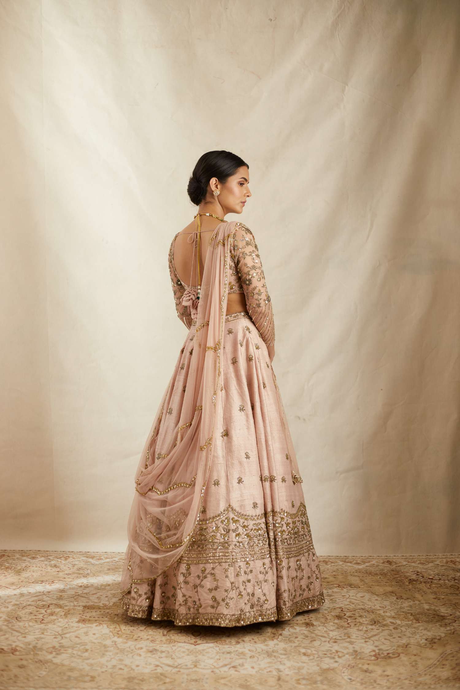 Back Angle View of Peach Pink Embroidered Raw Silk Lehenga Set