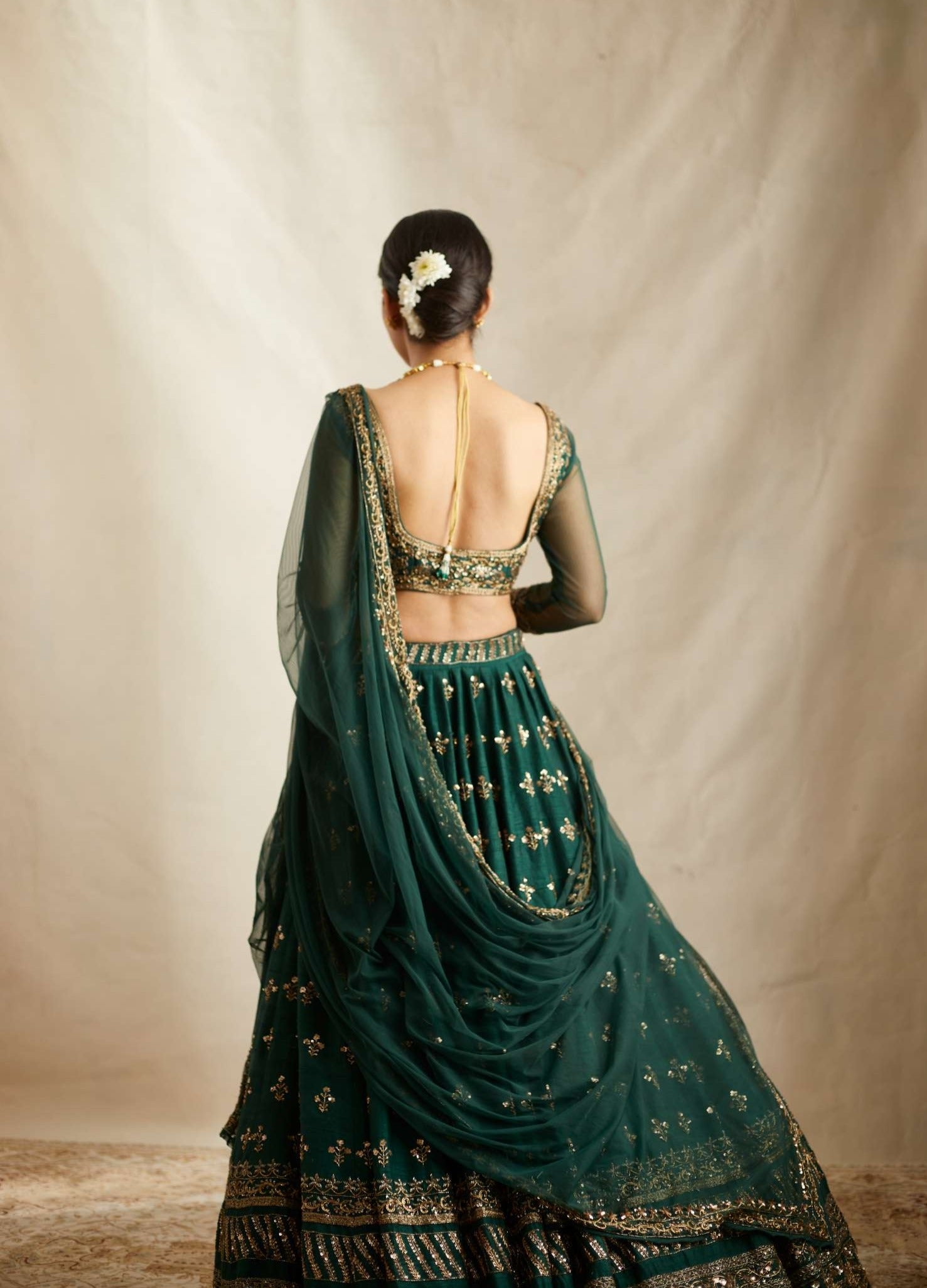 Back angle view of Embrelled Green Raw Silk Lehenga Set