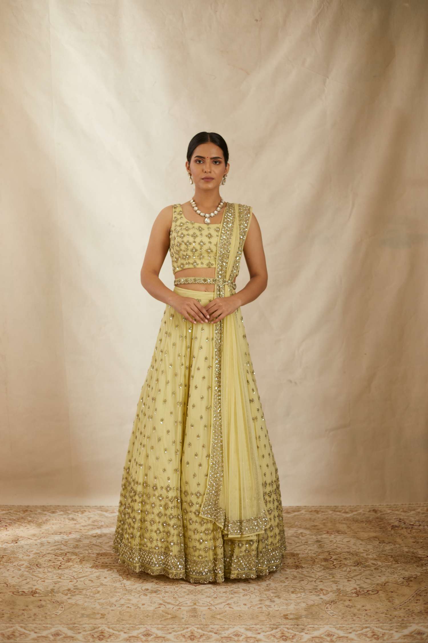 Front view of Yellow Net Crepe Embroidered Lehenga Set