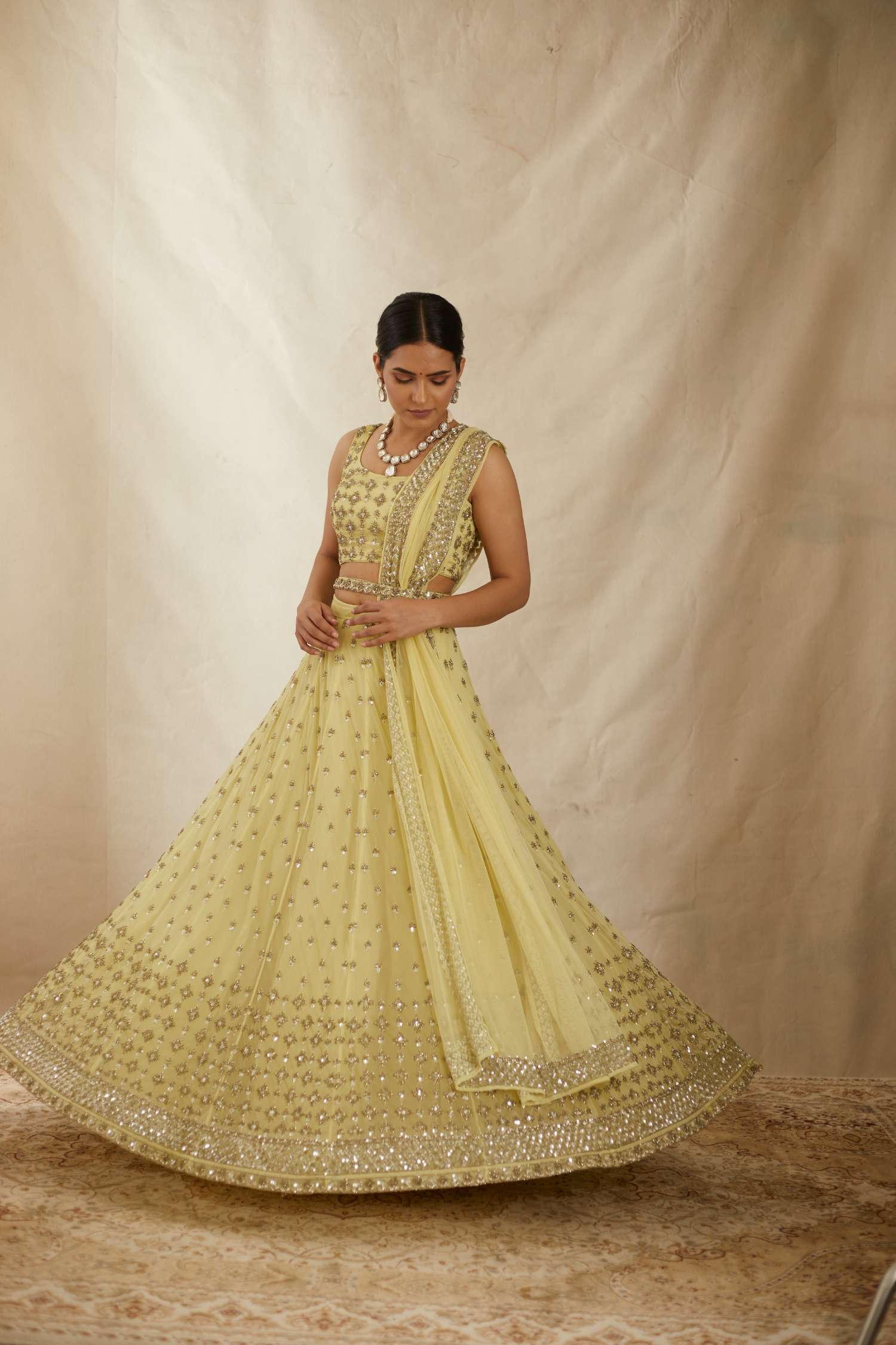 Front view of Yellow Net Crepe Embroidered Lehenga Set