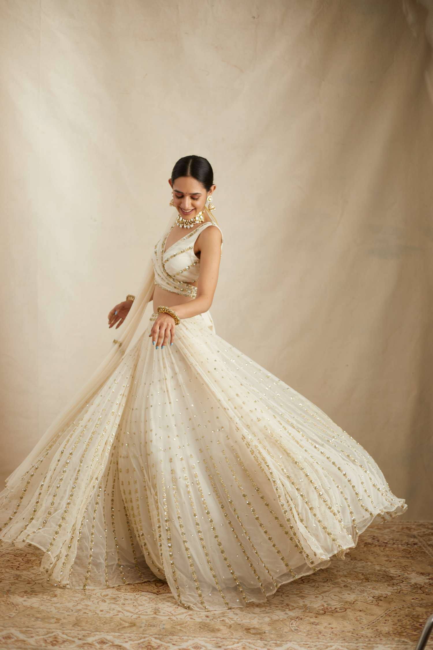 Side view of Off White Net Crepe Line Embroidered Lehenga Set
