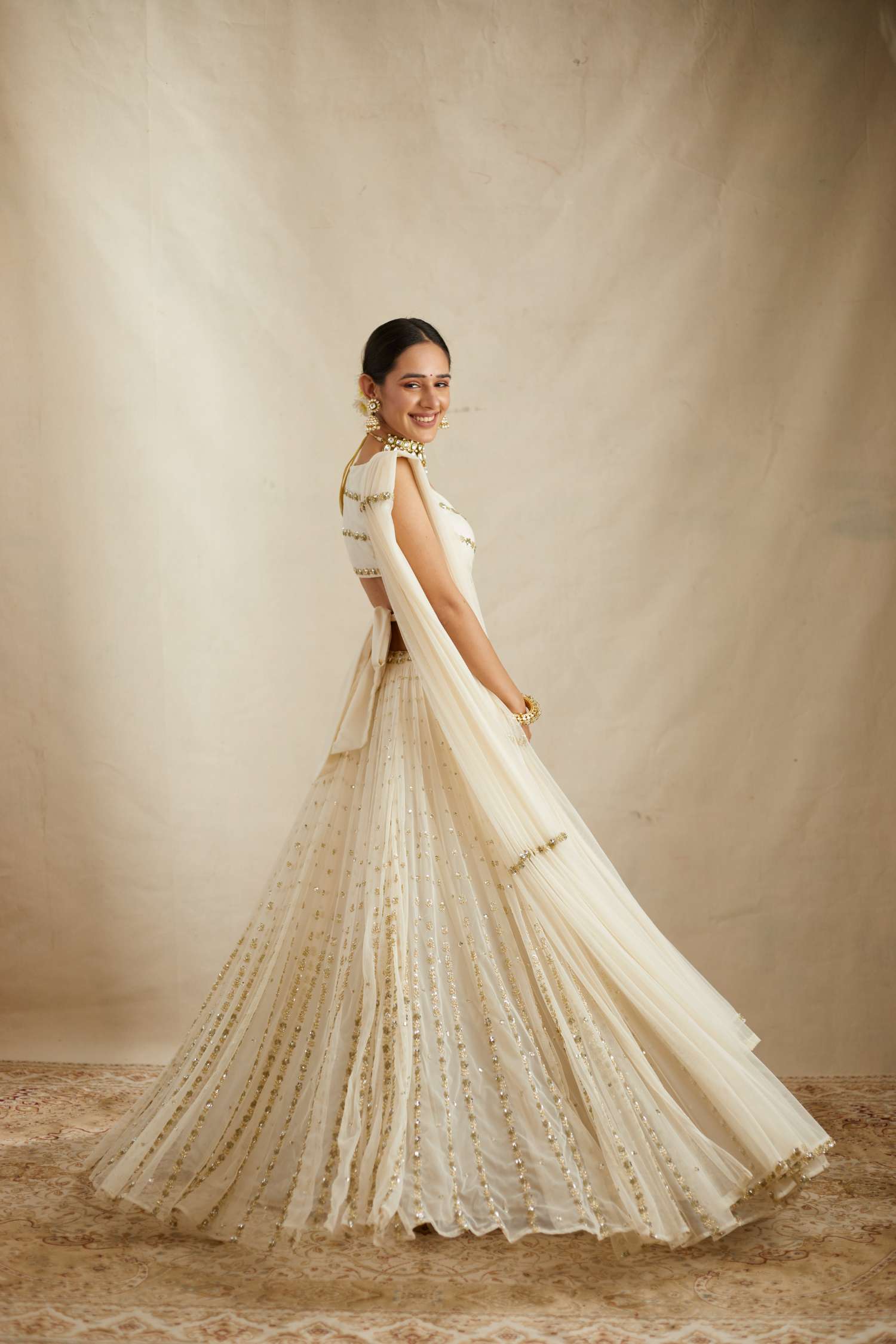 Side view of Off White Net Crepe Line Embroidered Lehenga Set for Women