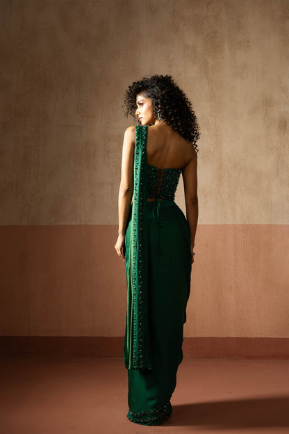 Predraped, emerald green hand embroidered satin saree with corset blouse