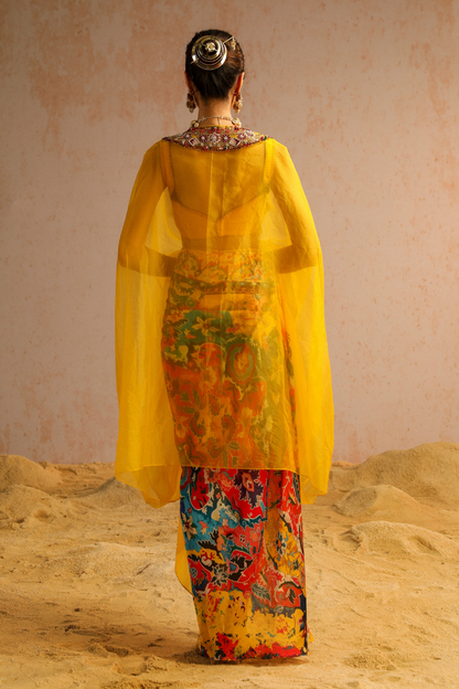 Yellow draped skirt with blouse and cape