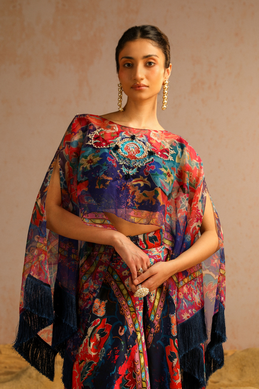 Blue pants with blouse and cape