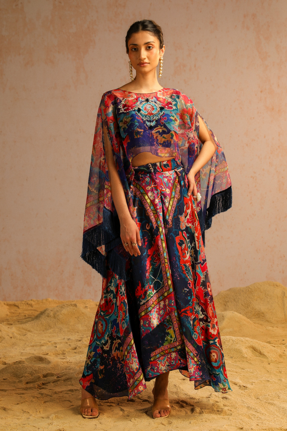 Blue pants with blouse and cape