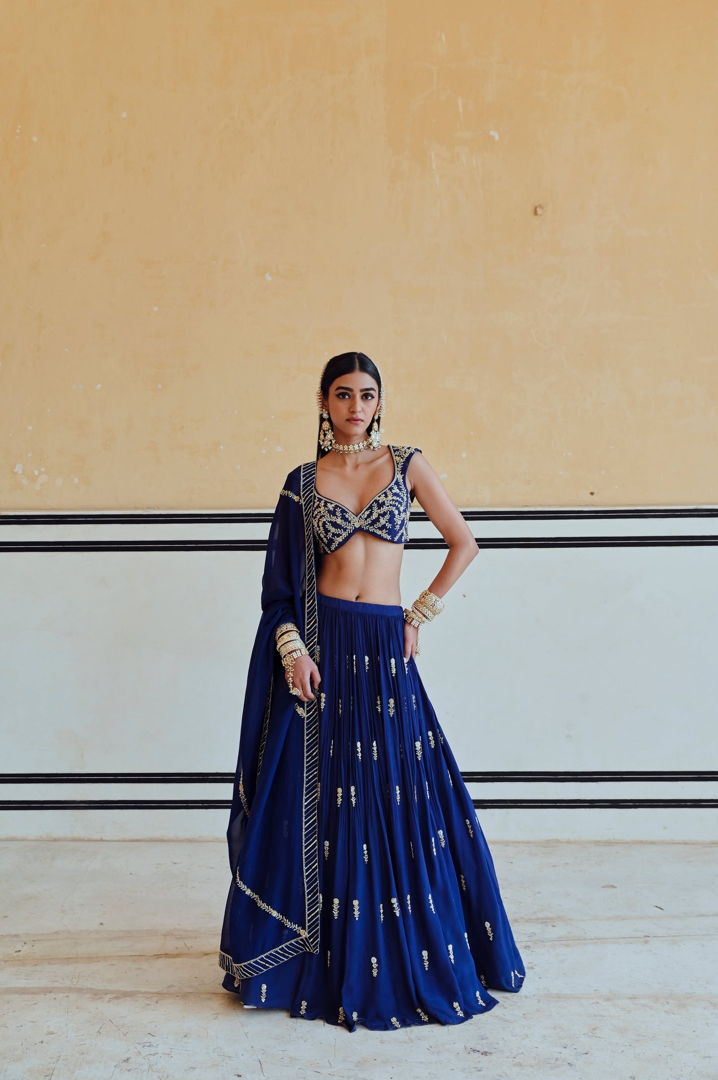 ROYAL BLUE DEEP NECKLINE EMBROIDERED SLEEVELESS BLOUSE WITH FLORAL BUTTI EMBROIDERED LEHENGA AND DUPATTA- EC-LH-RAHI25-25- RoyalBlue
