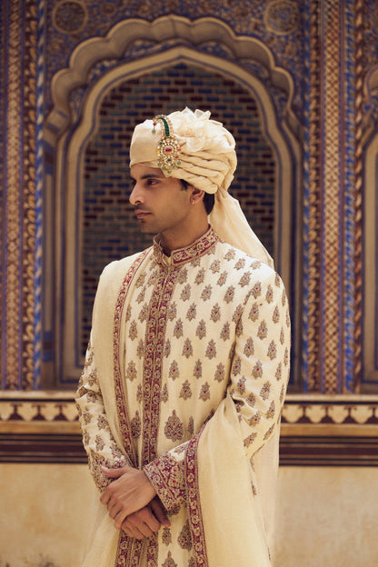 BEIGE RAW SILK SHERWANI WITH A COTTON SILK CHOGA AND CHURIDAR