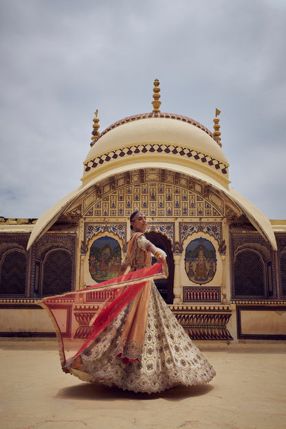 GOLD TISSUE LEHENGA CHOLI WITH A PEACH TISSUE  DUPATTA