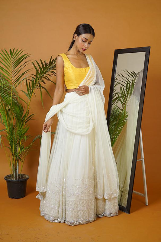 Mustard blouse with off white lehenga and dupatta